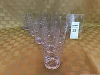 Group of 11 clear plastic tumblers arranged in rows, showing their translucent and textured bubble pattern.