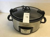 Front view of Crock-Pot slow cooker, showing stainless steel body, digital control panel, power cord, and handles.