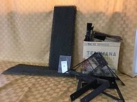 Overview of metal stair risers and treads with hardware brackets and cardboard box in background