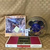 Photo showing three main items: Golden Glory 500-piece jigsaw puzzle box featuring deer in a winter scene, Disney Trivia game in a Mickey Mouse shaped tin, and backgammon game box with 30 plastic men and 2 dice.