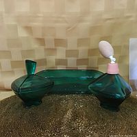 Photo showing the emerald green glass tray flanked by the covered dish and perfume automizer with pink bulb atomizer.