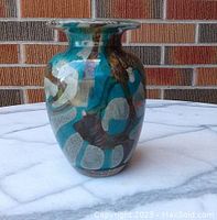 Front view of the Moline art glass urn vase showing swirling teal, brown, and white colors with wide flared top