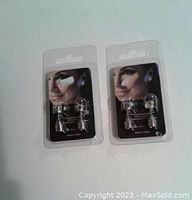Two pairs of LED earrings in clear plastic blister packs with black backing cards showing a woman wearing the earrings