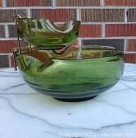 Side view of large and small bowls with gold-tone hanger, showing size and color details