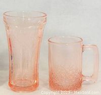 Front view of a pink depression glass soda glass and mug showing their intricate details and rose-pink color.