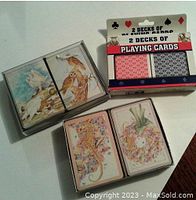 Two boxed standard decks with red and black backs plus 4 decorative sea-life themed decks showing seahorses and coral artwork.