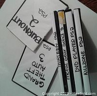 Photo showing Burnout 3 and Grand Theft Auto 3 discs in cases with handwritten labels and no covers.