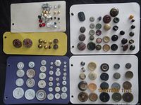 Overview of four cards with vintage and used buttons of many sizes, colors, and materials.