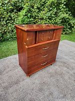 Front and angled view of medium brown wood Kroehler dresser with three large bottom drawers and four smaller upper drawers with brass handles and knobs.