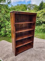 Full view of the solid pine bookshelf showing five shelves and wood grain finish.