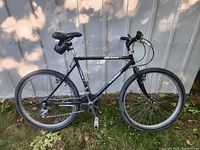 Side view of Raleigh Ozark bicycle showing full bike frame, tires, saddle, and pedals.