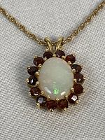 Close-up of pendant showing opal center and tourmaline surround