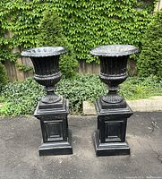 Full front view of both urns on bases