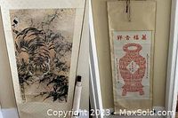 Two scrolls side by side: tiger scroll on left, red pot motif scroll on right