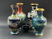 Group shot of all four cloisonne vases arranged around a green apple for scale.