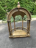 Front view of hand-made wooden band shell model showing arched canopy, columns and curved base
