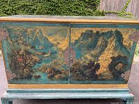 Front view of sideboard with painted Chinese landscape and hardware