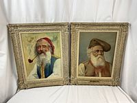Front view of both paintings side by side in carved painted wood frames