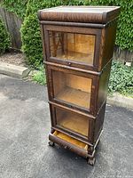 Front perspective view of the barrister bookcase showing three stacked compartments and dovetail base drawer.