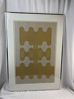 Full view of framed print showing abstract geometric design, white mat and silver metal frame.
