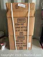 Two sealed, strapped cardboard boxes labeled to contain 12 spray bottles each, 32 oz size.