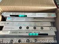 Photo showing a box containing 25 message rollers in their individual packaging with brand Gentle and other markings visible.