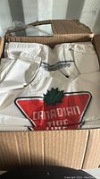 Photo showing the open box packed with white plastic bags featuring the Canadian Tire logo in red and green.
