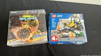 Boxed Metal Assembly Gyro and Lego City set shown together on black background, confirming contents and condition