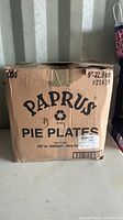 Closed cardboard box with printed text 'Papyrus Pie Plates 500 count 9in 22.9cm'