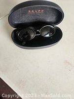 Ralph Lauren black oval sunglasses inside black hard case with Ralph Lauren branded interior