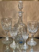 Group shot of decanter at center with four types of glasses arranged around