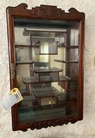 Full front view of rosewood cabinet mounted on wall