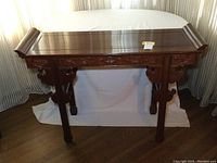 Front view of the rosewood altar table showing full piece and carved legs