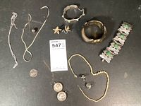 Top view of all sterling silver jewelry pieces displayed on black surface.