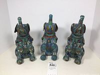 Three elephant-shaped cloisonné boxes facing forward on white background