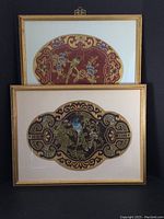 Photo showing single oval framed silk fabric with bird and floral embroidery in red, gold, and multiple colors.