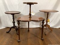 Front view of all three vintage wooden tables showing different shapes and bases.