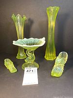 All five items shown together on black background: two tall vases, candy dish with sea creature base, and two small sea creature sculptures.