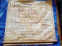 Full view of the antique scroll map including title and large U.S. map portion with edges visible