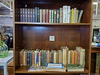 Combined photo showing both shelves with vintage and antique books with notable age wear
