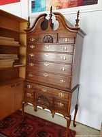 Front view showing drawer configuration, hardware, pediment, and overall finish