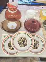 Photo showing three Italian pasta bowls with colored stripes and pasta graphic, amber Pyrex bowls, small white FireKing crock, colored glass baking dish lid visible.