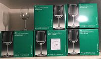 Five original boxes of Royal Leerdam Bouquet wine glasses arranged on a shelf, each box advertising 6 glasses, 35cl (12.5 oz) capacity.