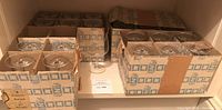 Boxes containing multiple Glas Ausi Zwiesel wine glasses packed securely in original cardboard holders.