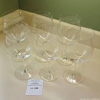 Six glasses displayed together on white countertop