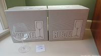 Two original Riedel boxes with one glass placed in front and lot card visible