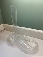 Full profile view showing coiled snake base and tall neck