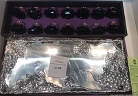 Boxed set including the 19-inch aluminum serving tray with grapevine motif and the 14 matching aluminum napkin rings in black cases.