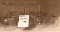 Set of 12 unmarked crystal red wine glasses upside down, showing clear stems and bases
