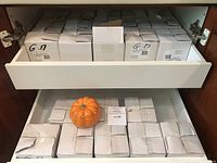 Drawer filled with 24 white original boxes